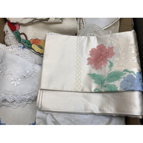 560 - Two boxes containing a collection of vintage embroidered and lace linen