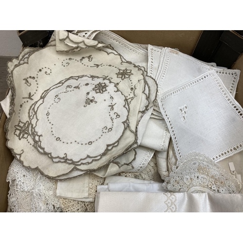 560 - Two boxes containing a collection of vintage embroidered and lace linen