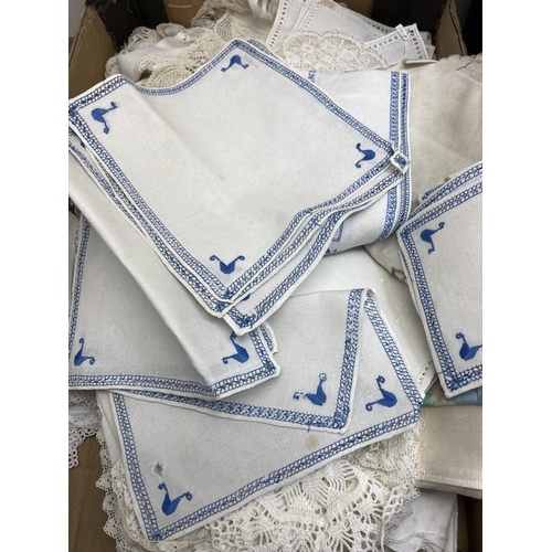 560 - Two boxes containing a collection of vintage embroidered and lace linen