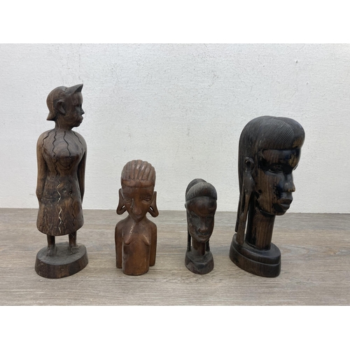 602 - A collection of carved treen figurines to include African Trible style busts, elephants etc.