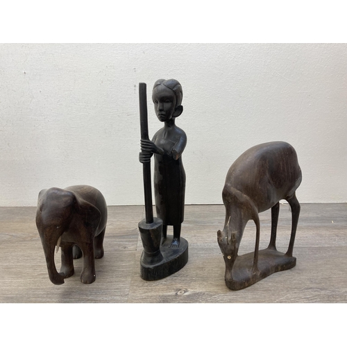 602 - A collection of carved treen figurines to include African Trible style busts, elephants etc.