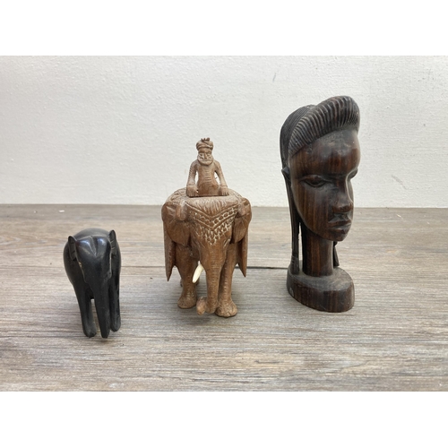 602 - A collection of carved treen figurines to include African Trible style busts, elephants etc.