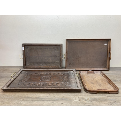 603 - Four antique and later carved wooden serving trays - largest approx. 43cm high x 66cm wide