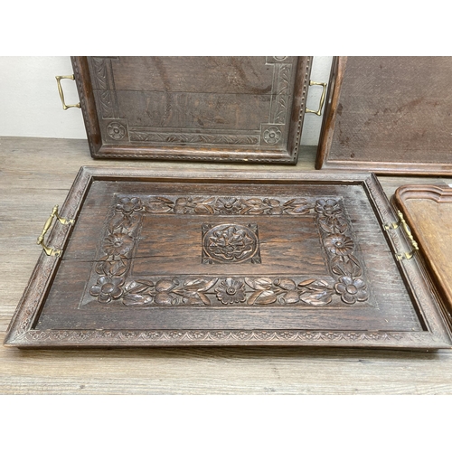 603 - Four antique and later carved wooden serving trays - largest approx. 43cm high x 66cm wide