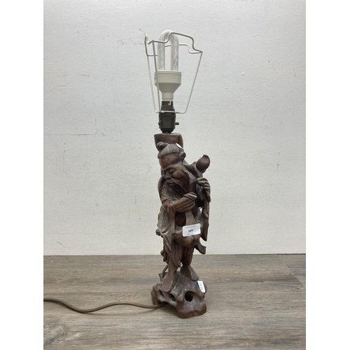 609 - A Chinese carved hardwood elder figural table lamp - approx. 55cm high (including bulb holder)