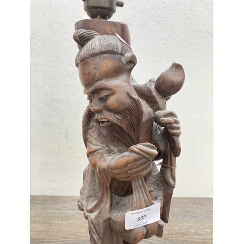 609 - A Chinese carved hardwood elder figural table lamp - approx. 55cm high (including bulb holder)