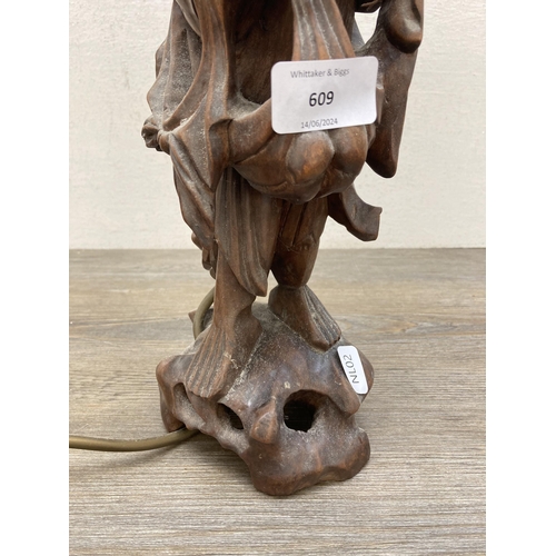 609 - A Chinese carved hardwood elder figural table lamp - approx. 55cm high (including bulb holder)