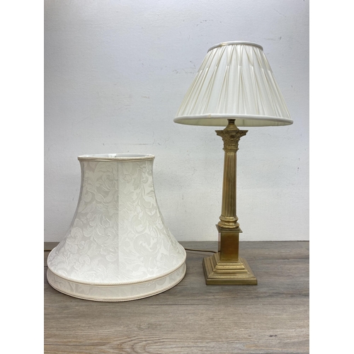 610A - A Laura Ashley Georgian style brass Corinthian table lamp with two cream shades