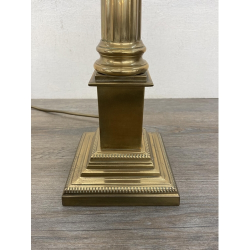 610A - A Laura Ashley Georgian style brass Corinthian table lamp with two cream shades