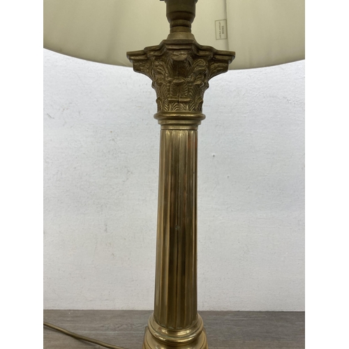 610A - A Laura Ashley Georgian style brass Corinthian table lamp with two cream shades