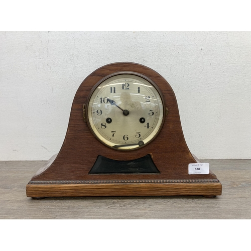 628 - A 1940s oak cased Napoleon Hat chiming mantel clock