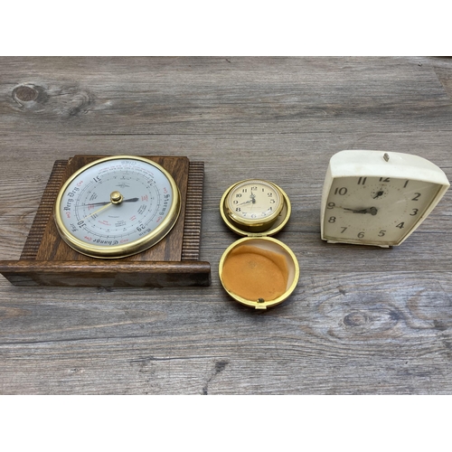 631 - A collection of mid 20th century clocks and barometers to include oak cased Shortland Smiths oak cas... 