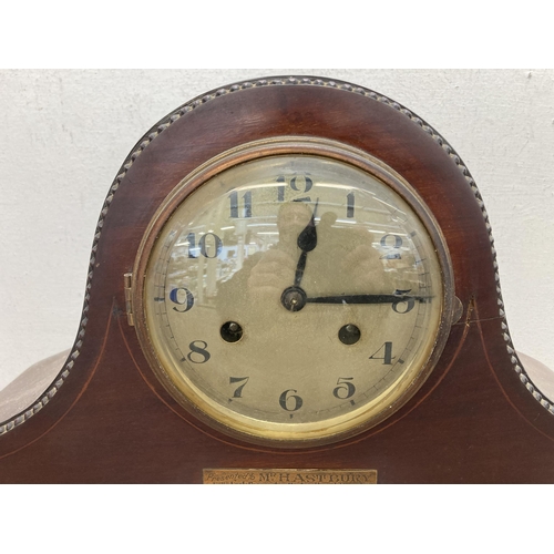 632 - A 1920s inlaid mahogany chiming presentation mantel clock - presented to Mr. Hastbury by the Leek Co... 