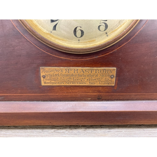 632 - A 1920s inlaid mahogany chiming presentation mantel clock - presented to Mr. Hastbury by the Leek Co... 