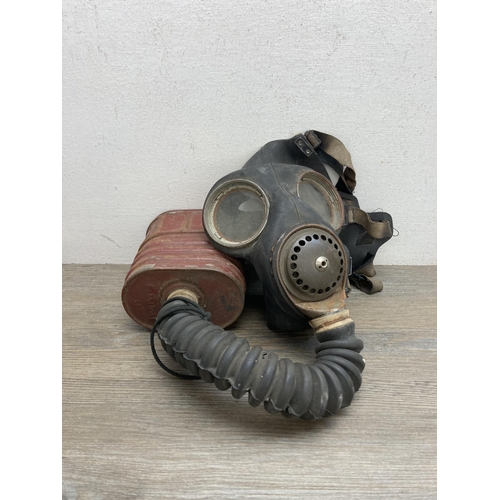 635B - Three pieces of militaria, one No.4 gas mask and two WWII helmets