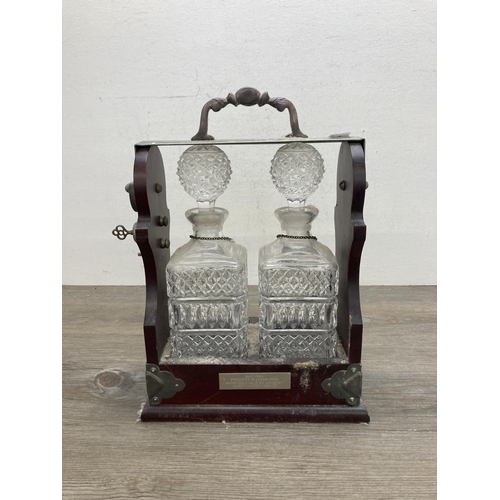 640 - A vintage mahogany presentation tantalus with two pressed glass decanters -approx. 35cm high x 24cm ... 