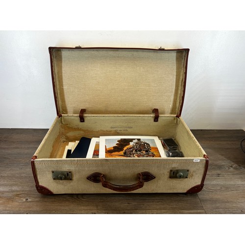 591 - A mid 20th century brown canvas and leather military travel trunk containing a collection of items t... 