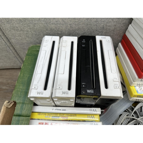 666 - Four Nintendo Wii consoles with controllers, power supplies, games and a large collection of accesso... 