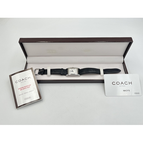 2235 - A boxed Coach W502B stainless steel quartz wristwatch with leather strap, service guide and warranty... 