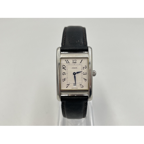 2235 - A boxed Coach W502B stainless steel quartz wristwatch with leather strap, service guide and warranty... 