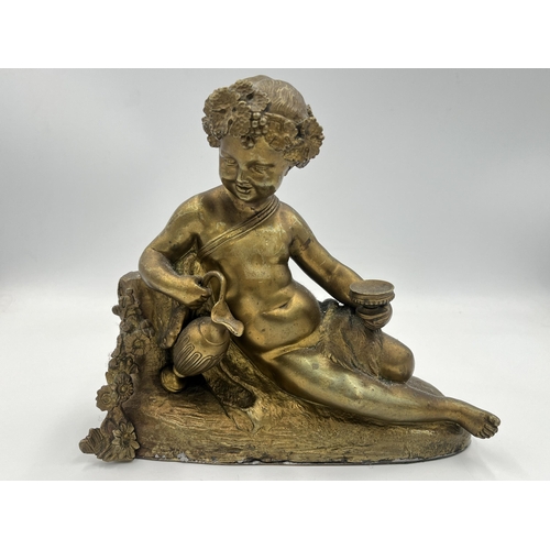 2291 - A Neoclassical style gilded cast metal figurine of a cherub - approx. 18cm high x 20cm wide