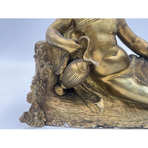 2291 - A Neoclassical style gilded cast metal figurine of a cherub - approx. 18cm high x 20cm wide