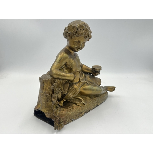 2291 - A Neoclassical style gilded cast metal figurine of a cherub - approx. 18cm high x 20cm wide