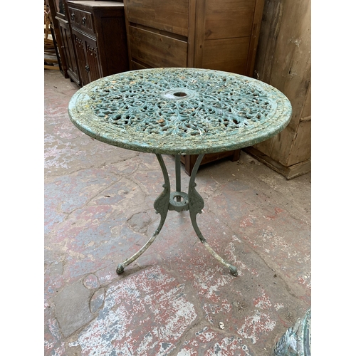107 - A Victorian style green painted cast metal three piece patio set - table approx. 73cm high x 69cm di... 