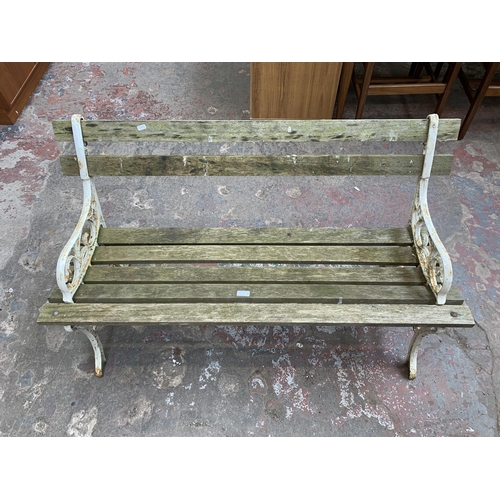 108 - Three pieces of garden furniture, two teak folding chairs and one Victorian style cast metal and woo... 