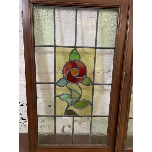 12 - A pair of 1930s mahogany framed stained and lead glass windows - approx. 82cm high x 48cm wide