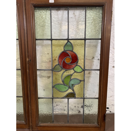 12 - A pair of 1930s mahogany framed stained and lead glass windows - approx. 82cm high x 48cm wide