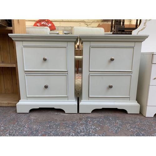 121 - A pair of modern white painted bedside chests of drawers - approx. 61cm high x 49cm wide x 38cm deep