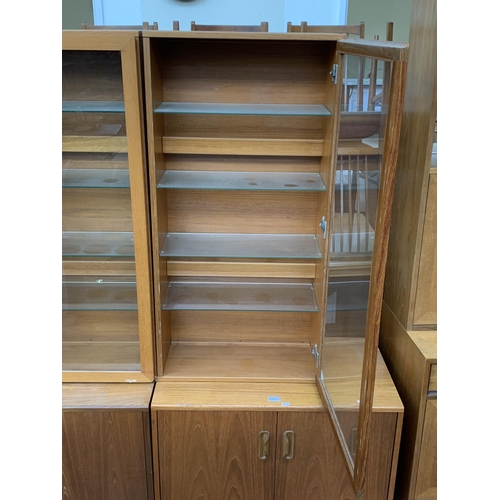 129 - A pair of mid 20th century Tapley 33 teak wall mountable display cabinets - approx. 112cm high x 56c... 