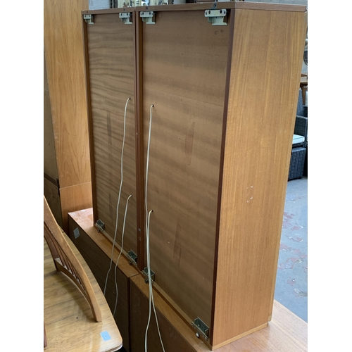 129 - A pair of mid 20th century Tapley 33 teak wall mountable display cabinets - approx. 112cm high x 56c... 