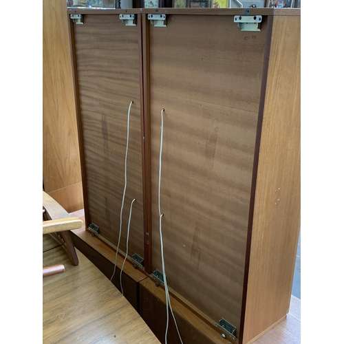 129 - A pair of mid 20th century Tapley 33 teak wall mountable display cabinets - approx. 112cm high x 56c... 