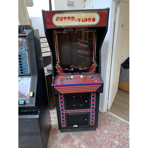 130 - A Super Video arcade machine, serial no. 23205 - approx. 183cm high x 65cm wide x 83cm deep