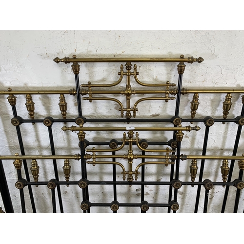 133 - A Victorian brass and cast iron double bed frame - approx. 138cm wide x 150cm high