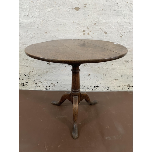 138 - A George III oak circular tilt top tripod occasional table - approx. 115cm high x 80cm diameter