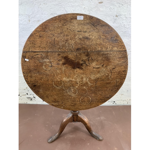 138 - A George III oak circular tilt top tripod occasional table - approx. 115cm high x 80cm diameter