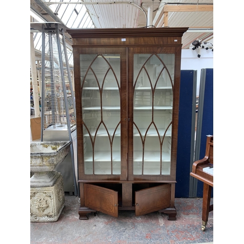 143 - An early 20th century mahogany and glazed display cabinet on bracket supports - approx. 196cm high x... 