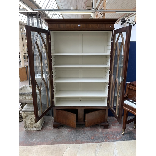143 - An early 20th century mahogany and glazed display cabinet on bracket supports - approx. 196cm high x... 