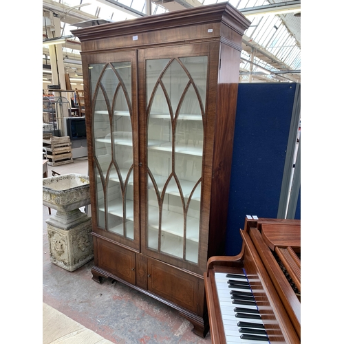 143 - An early 20th century mahogany and glazed display cabinet on bracket supports - approx. 196cm high x... 