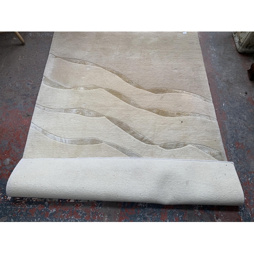 144 - A modern cream rug - approx. 210cm x 152cm