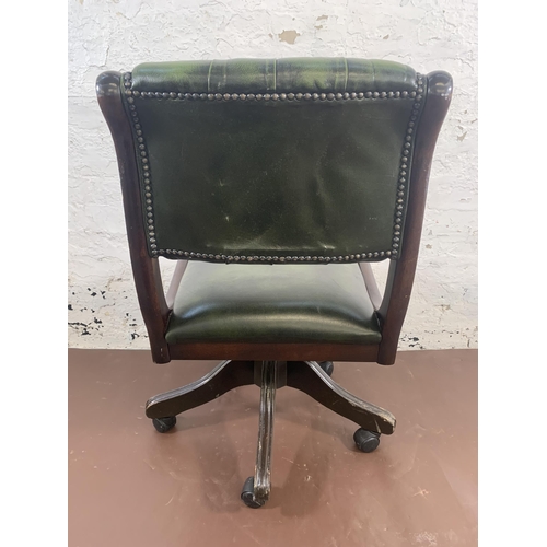 159 - A mahogany and green leather Chesterfield swivel desk chair