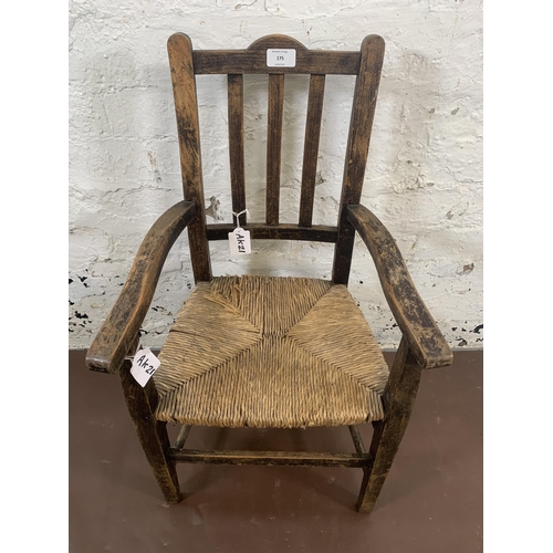 175 - An early 20th century beech and rush seated child's armchair