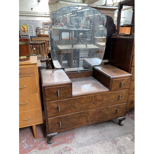 180 - An Art Deco style walnut dressing table with upper bevelled edge mirror