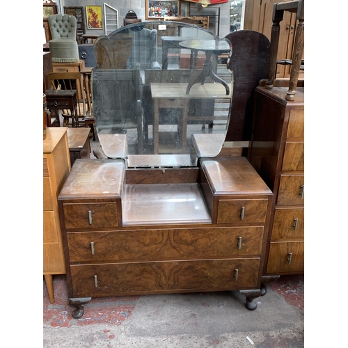 180 - An Art Deco style walnut dressing table with upper bevelled edge mirror