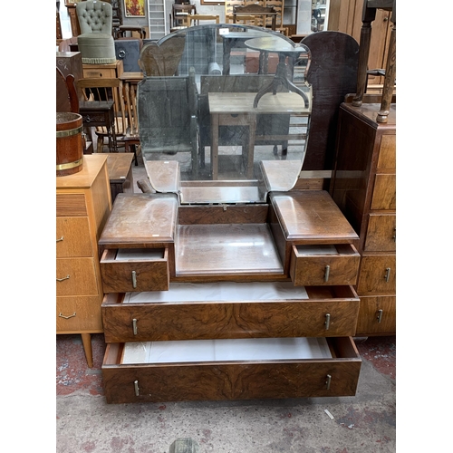 180 - An Art Deco style walnut dressing table with upper bevelled edge mirror