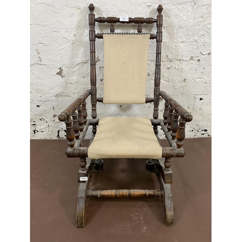 183 - An early 20th century American turned beech and fabric upholstered child's rocking chair - approx. 7... 