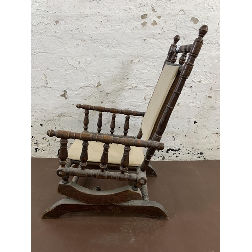 183 - An early 20th century American turned beech and fabric upholstered child's rocking chair - approx. 7... 